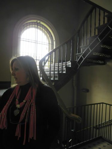 Photos by Heather Ziegler West Virginia Independence Hall Site Director Debbie Jones is shown near a staircase that leads to an upper floor where juries used to deliberate federal court cases in the id-1800s.